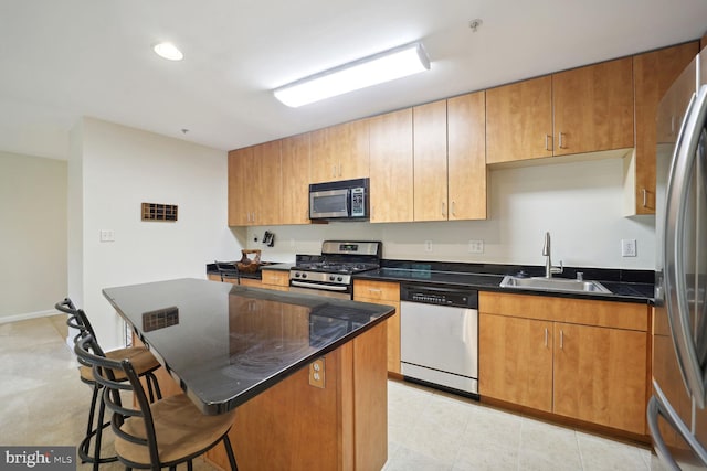 1117 Primrose Ct Unit 304, Annapolis, MD 21403 - kitchen with appliances with stainless steel finishes, a sink, a breakfast bar area, a kitchen island, and recessed lighting