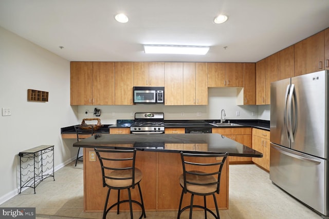 1117 Primrose Ct Unit 304, Annapolis, MD 21403 - kitchen with stainless steel appliances, a sink, a kitchen island, a kitchen breakfast bar, and dark countertops