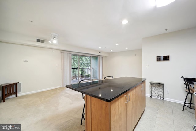 1117 Primrose Ct Unit 304, Annapolis, MD 21403 - kitchen with a breakfast bar area, baseboards, a center island, recessed lighting, and ceiling fan