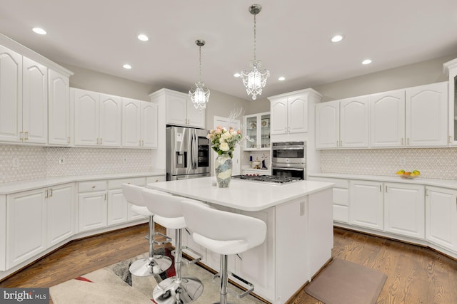 12436 Bacall Ln, Potomac, MD 20854 - kitchen featuring stainless steel appliances, recessed lighting, a center island, tasteful backsplash, and a chandelier
