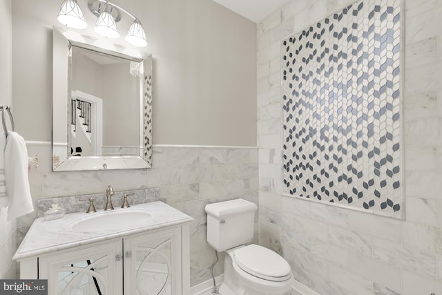 12436 Bacall Ln, Potomac, MD 20854 - bathroom featuring toilet, vanity, tile walls, and a wainscoted wall