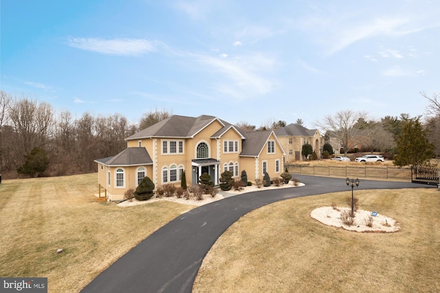 12436 Bacall Ln, Potomac, MD 20854 - colonial house featuring stucco siding and curved driveway