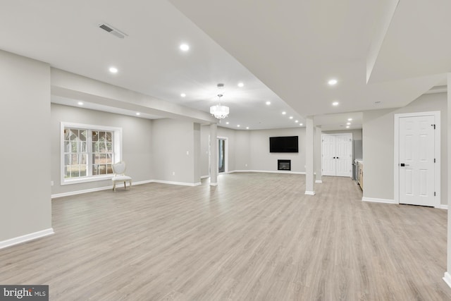 12436 Bacall Ln, Potomac, MD 20854 - unfurnished living room featuring baseboards, light wood finished floors, recessed lighting, a glass covered fireplace, and a chandelier