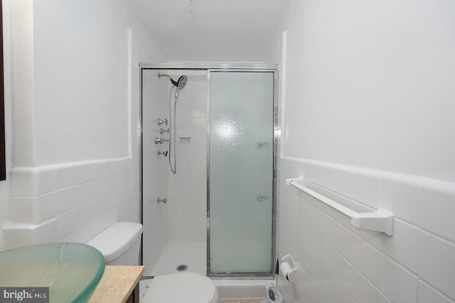 3852 Conshohocken Ave, Philadelphia, PA 19131 - full bath with tile walls, a stall shower, toilet, vanity, and wainscoting