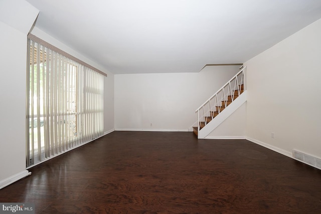 3852 Conshohocken Ave, Philadelphia, PA 19131 - unfurnished living room featuring baseboards, stairway, and wood finished floors