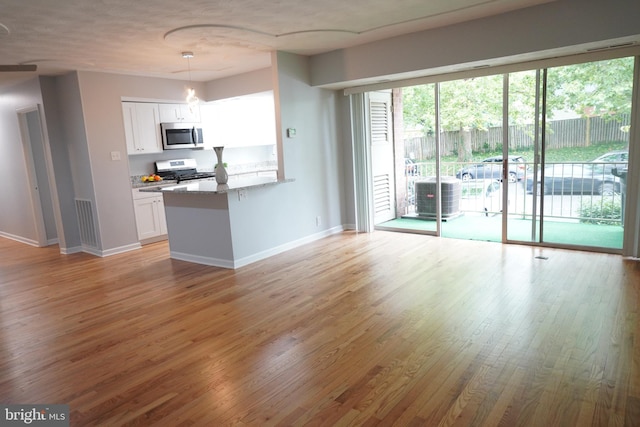 3700 N Rosser St Unit 104, Alexandria, VA 22311 - kitchen featuring stainless steel microwave, stove, white cabinetry, and light wood-style floors