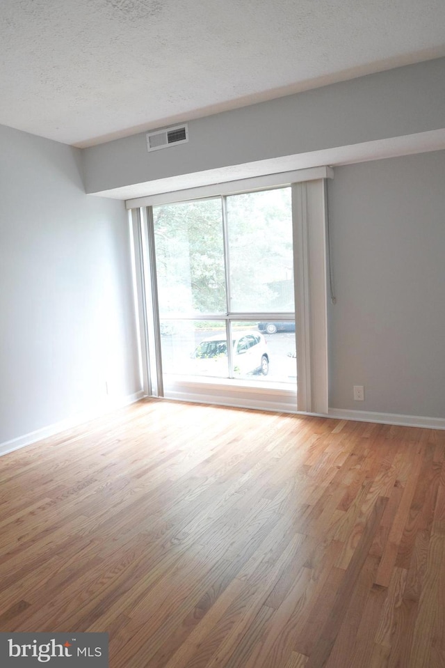 3700 N Rosser St Unit 104, Alexandria, VA 22311 - empty room featuring wood finished floors and a textured ceiling