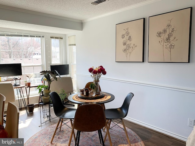 1504 Lincoln Way Unit 305, Mclean, VA 22102 - dining space featuring wood finished floors, a textured ceiling, ornamental molding, a desk, and baseboards