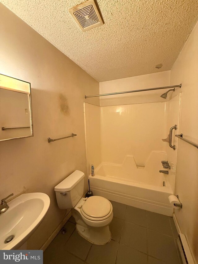 28 Myrtle Dr, Gerrardstown, WV 25420 - full bathroom with a sink, baseboard heating, a textured ceiling, toilet, and tile patterned flooring
