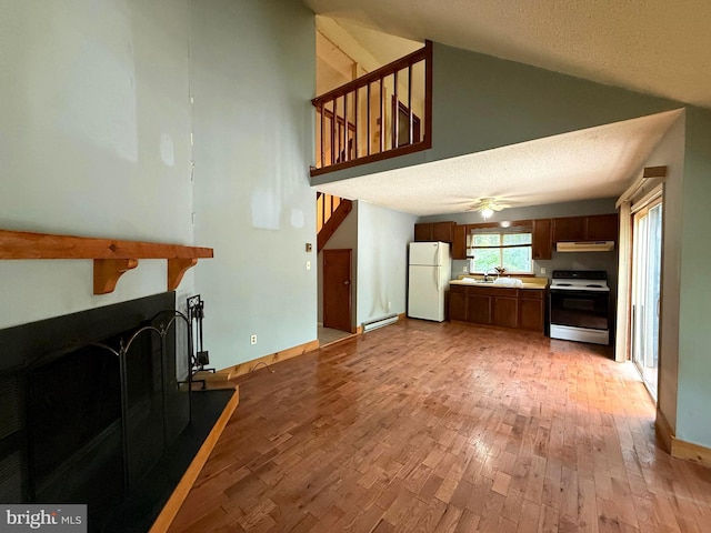 28 Myrtle Dr, Gerrardstown, WV 25420 - living room featuring a baseboard radiator, light wood-style floors, high vaulted ceiling, a ceiling fan, and a textured ceiling