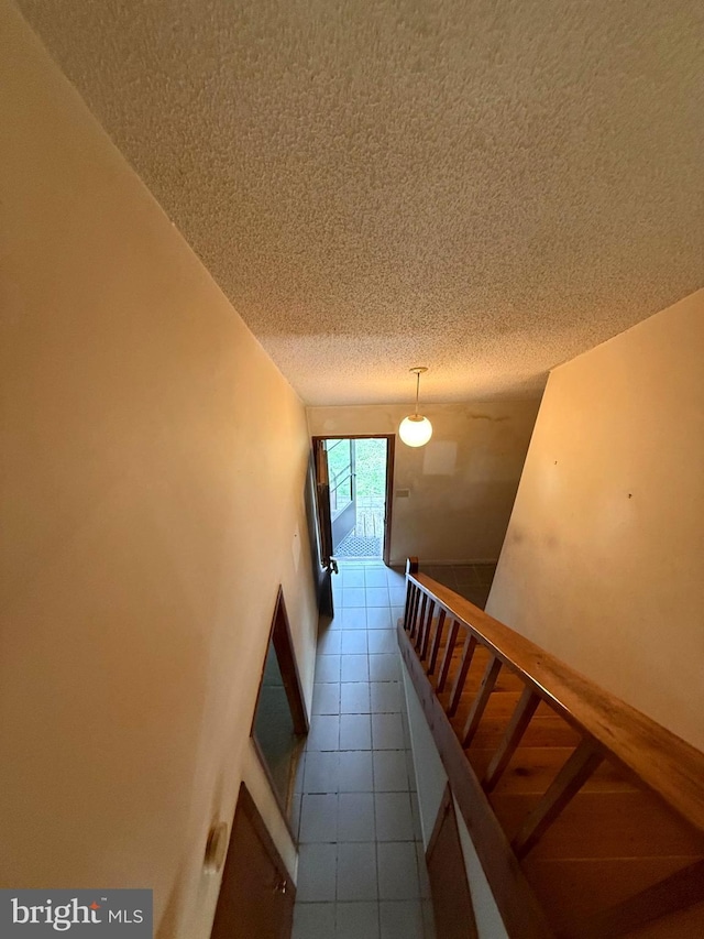 28 Myrtle Dr, Gerrardstown, WV 25420 - staircase featuring tile patterned floors and a textured ceiling