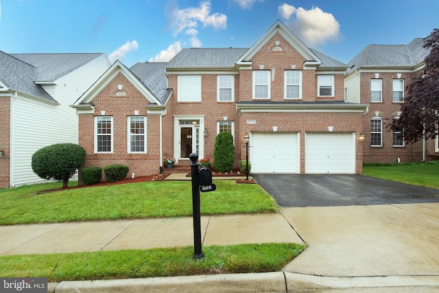 9573 5th Pl, Lorton, VA 22079 - view of front of home with driveway, brick siding, a front lawn, and a garage