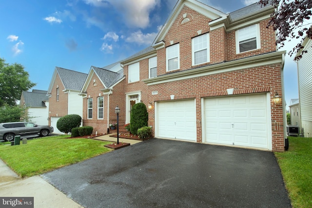 9573 5th Pl, Lorton, VA 22079 - view of front of house featuring brick siding, a garage, and driveway
