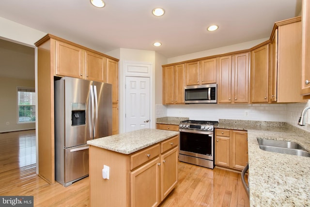 9573 5th Pl, Lorton, VA 22079 - kitchen with appliances with stainless steel finishes, a kitchen island, light wood-style floors, decorative backsplash, and recessed lighting