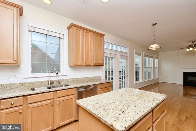 9573 5th Pl, Lorton, VA 22079 - kitchen with light wood-style floors, ceiling fan, a glass covered fireplace, open floor plan, and a center island