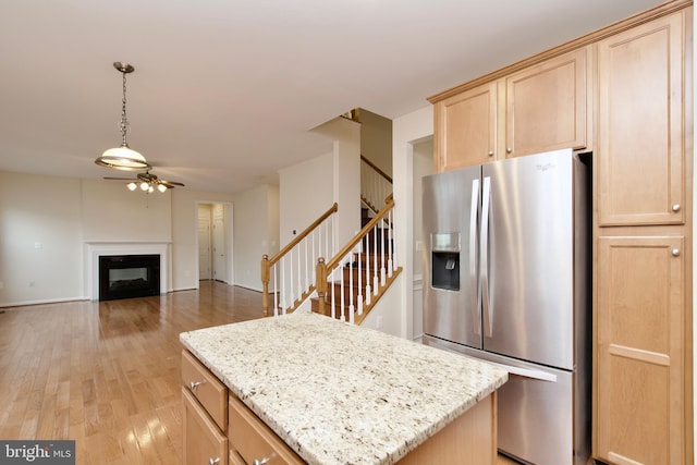 9573 5th Pl, Lorton, VA 22079 - kitchen with stainless steel refrigerator with ice dispenser, light brown cabinets, ceiling fan, and light wood finished floors
