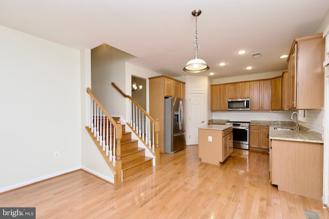 9573 5th Pl, Lorton, VA 22079 - kitchen featuring stainless steel appliances, recessed lighting, light wood finished floors, a kitchen island, and tasteful backsplash