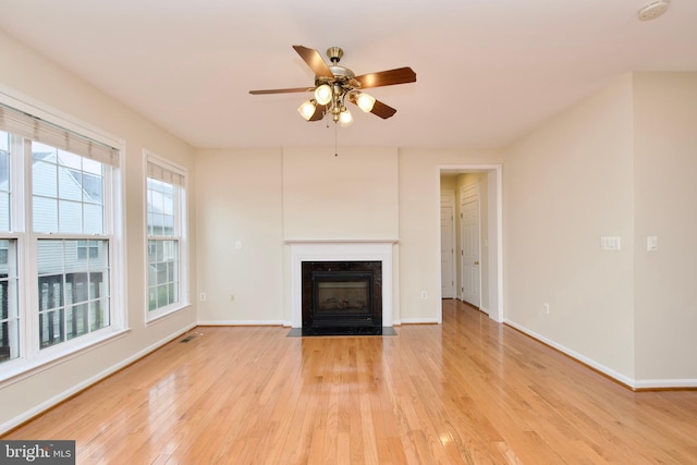 9573 5th Pl, Lorton, VA 22079 - unfurnished living room featuring light wood finished floors, ceiling fan, and a fireplace with flush hearth
