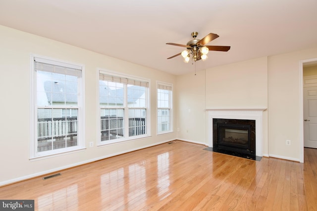 9573 5th Pl, Lorton, VA 22079 - unfurnished living room with a ceiling fan, wood finished floors, and a fireplace with flush hearth