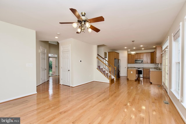 9573 5th Pl, Lorton, VA 22079 - unfurnished living room with stairway, recessed lighting, ceiling fan, and light wood finished floors