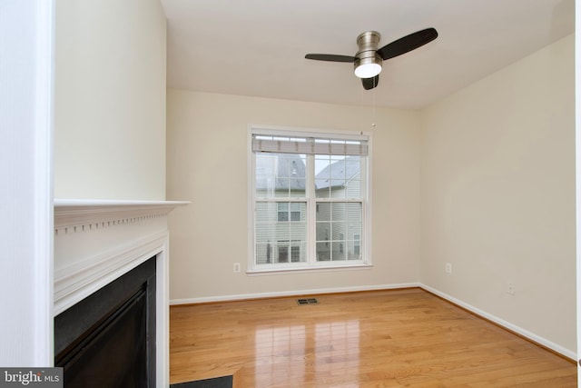 9573 5th Pl, Lorton, VA 22079 - unfurnished living room featuring a fireplace, light wood-type flooring, and a ceiling fan