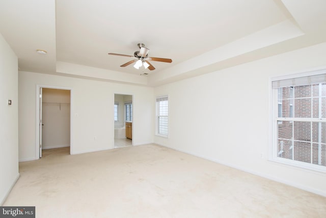 9573 5th Pl, Lorton, VA 22079 - unfurnished bedroom featuring a tray ceiling, light colored carpet, and a spacious closet