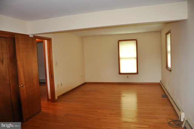3202 Holly Ln, Cambridge, MD 21613 - empty room with baseboard heating, light wood-style flooring, and baseboards