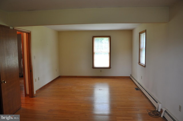 3202 Holly Ln, Cambridge, MD 21613 - spare room featuring a baseboard radiator, light wood-style floors, and baseboards