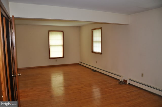 3202 Holly Ln, Cambridge, MD 21613 - spare room with wood finished floors, baseboard heating, and plenty of natural light