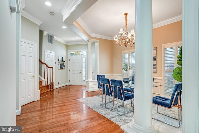 5968 Manorview Way, Alexandria, VA 22315 - foyer entrance featuring decorative columns, ornamental molding, stairway, light wood finished floors, and a chandelier