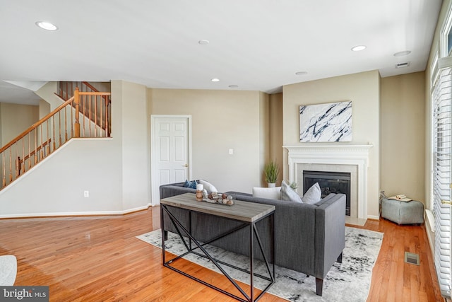 5968 Manorview Way, Alexandria, VA 22315 - living area featuring light wood-style floors, stairway, a fireplace with flush hearth, and recessed lighting