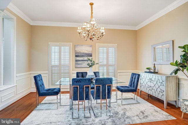 5968 Manorview Way, Alexandria, VA 22315 - dining area with wood finished floors, crown molding, a chandelier, a wainscoted wall, and a decorative wall