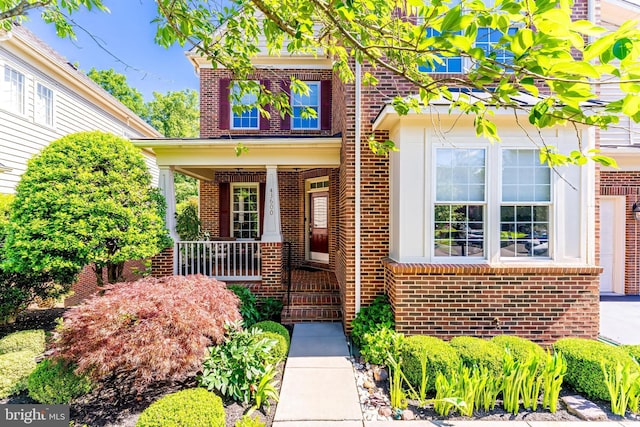 43600 Habitat Cir, Leesburg, VA 20176 - property entrance with brick siding and a porch