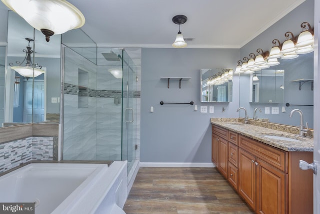 4109 Leisure Dr, Temple Hills, MD 20748 - full bath featuring crown molding, double vanity, a shower stall, wood finished floors, and a garden tub