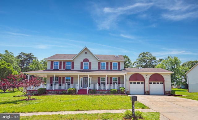 4109 Leisure Dr, Temple Hills, MD 20748 - colonial-style house featuring a garage, driveway, covered porch, and a front yard