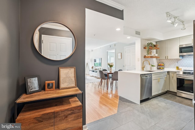 3101 N Hampton Dr Unit 314, Alexandria, VA 22302 - kitchen with appliances with stainless steel finishes, open shelves, a sink, light countertops, and decorative backsplash