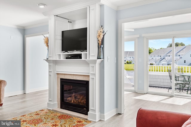 9729 Village Ln Unit 9715C, Ocean City, MD 21842 - living room with light wood-type flooring, a tiled fireplace, crown molding, and baseboards