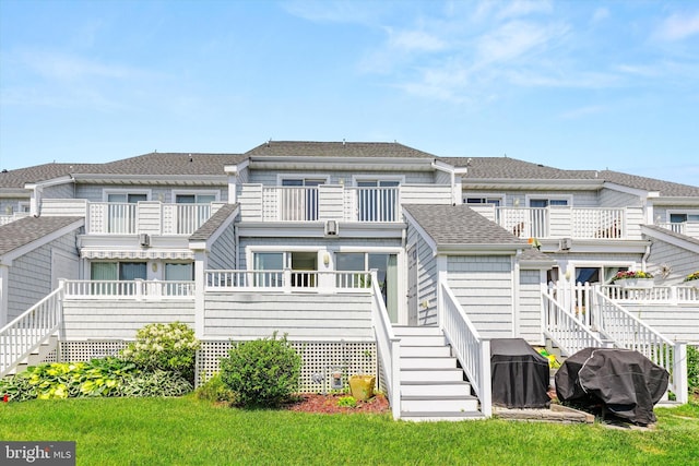 9729 Village Ln Unit 9715C, Ocean City, MD 21842 - rear view of property with a balcony, stairway, roof with shingles, and a lawn