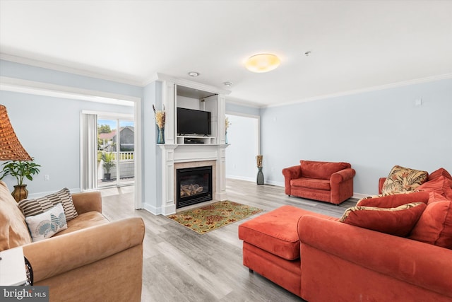 9729 Village Ln Unit 9715C, Ocean City, MD 21842 - living area featuring crown molding, light wood-style floors, a glass covered fireplace, and baseboards