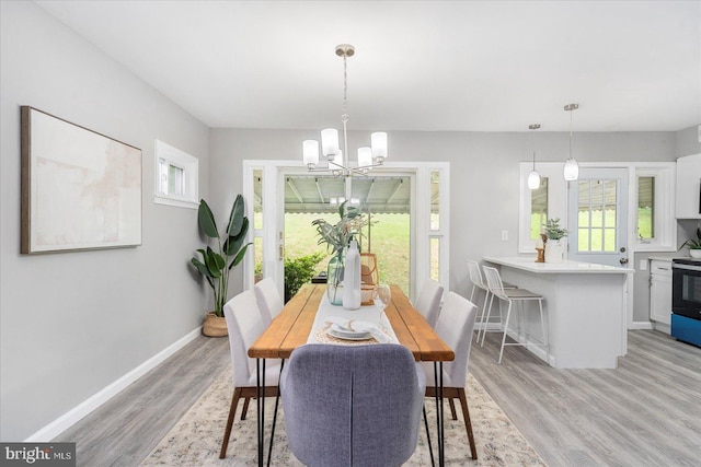 3910 The Alameda, Baltimore, MD 21218 - dining space featuring a chandelier, light wood-type flooring, and baseboards