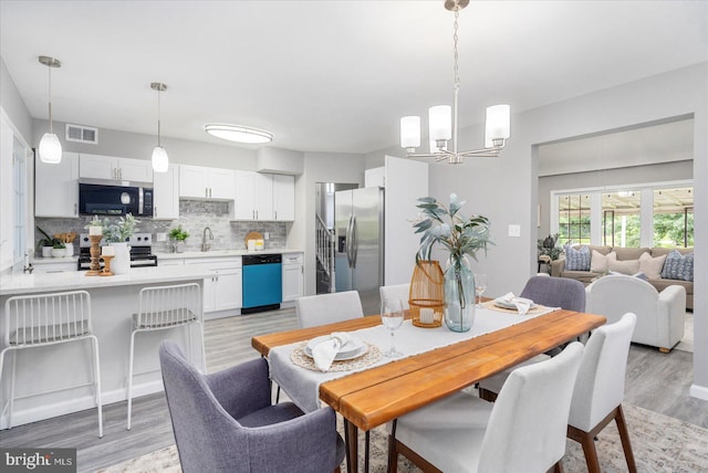 3910 The Alameda, Baltimore, MD 21218 - dining area with a chandelier and light wood finished floors