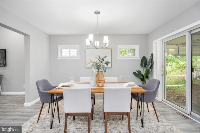 3910 The Alameda, Baltimore, MD 21218 - dining space featuring a chandelier, wood finished floors, and baseboards