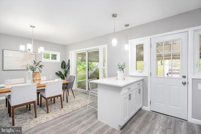 3910 The Alameda, Baltimore, MD 21218 - kitchen with a chandelier, light wood-style floors, white cabinets, light countertops, and decorative light fixtures