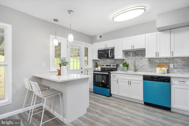 3910 The Alameda, Baltimore, MD 21218 - kitchen featuring appliances with stainless steel finishes, a sink, and white cabinetry