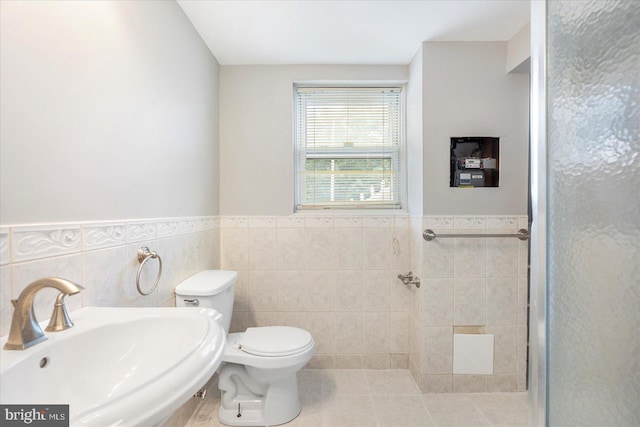 3910 The Alameda, Baltimore, MD 21218 - bathroom featuring a sink, toilet, tile walls, a wainscoted wall, and a shower