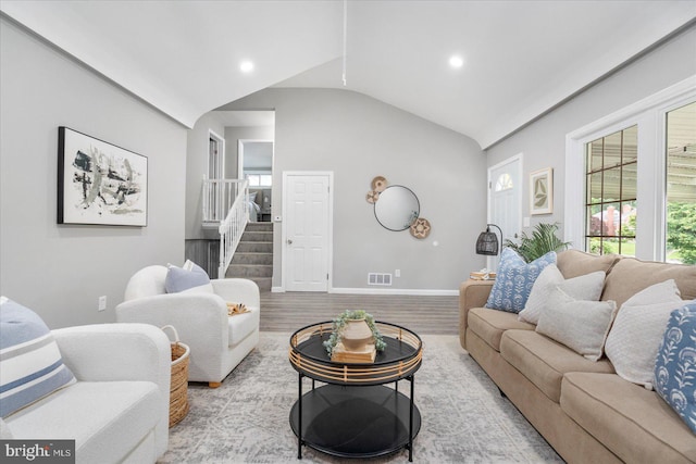 3910 The Alameda, Baltimore, MD 21218 - living room featuring lofted ceiling, healthy amount of natural light, stairs, baseboards, and wood finished floors