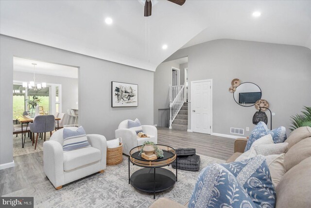 3910 The Alameda, Baltimore, MD 21218 - living room featuring wood finished floors, stairway, a chandelier, ceiling fan, and vaulted ceiling