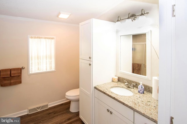 312 Farm Ln, North Wales, PA 19454 - bathroom with vanity, toilet, crown molding, wood finished floors, and baseboards
