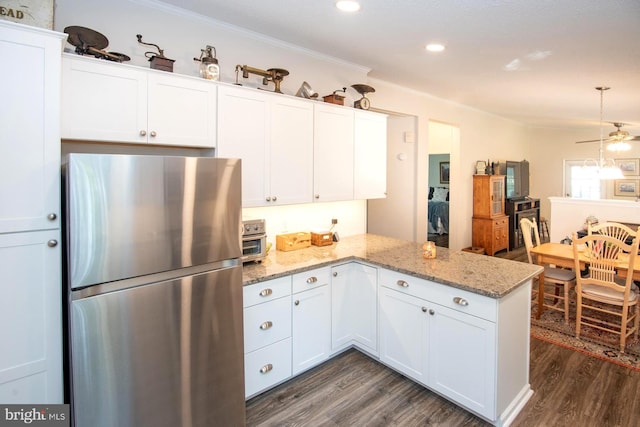 312 Farm Ln, North Wales, PA 19454 - kitchen with freestanding refrigerator, dark wood-type flooring, ornamental molding, white cabinets, and a peninsula