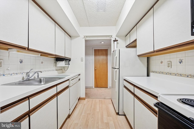 800 Avondale Rd Unit 2C, Wallingford, PA 19086 - kitchen with a sink, white appliances, white cabinets, light countertops, and a textured ceiling